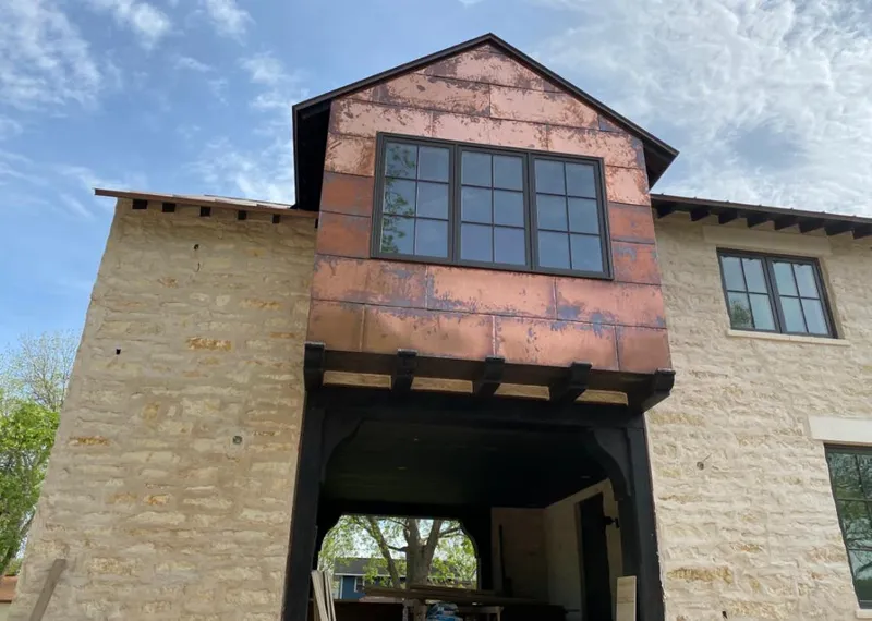 Copper metal panel facade on a stone building for Skylight Installation in Rocky Mount