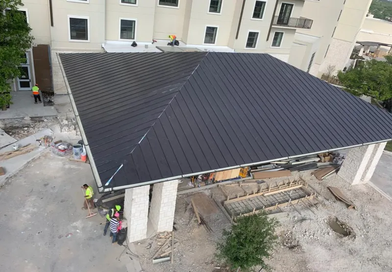 Metal roofing installation team working on a commercial building in Rocky Mount